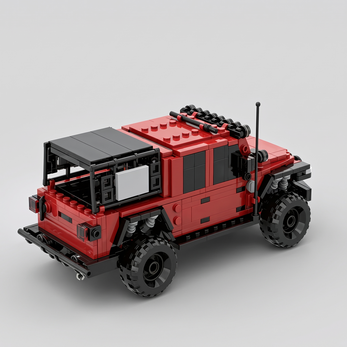 Pick-up tout-terrain rouge en briques de construction, vue de trois quarts arrière montrant la galerie de toit