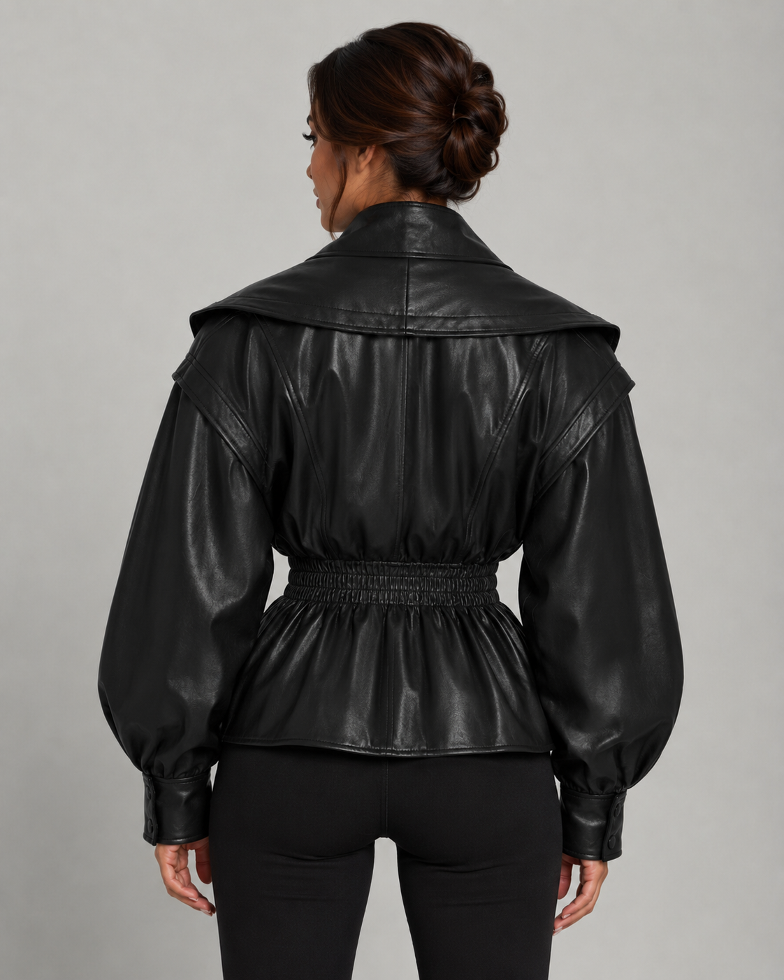Dos de la veste peplum femme noire, taille froncée élastique et basque évasée