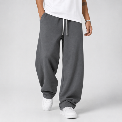 Pantalon jogging homme gris foncé coupe large avec cordon blanc, vue de face