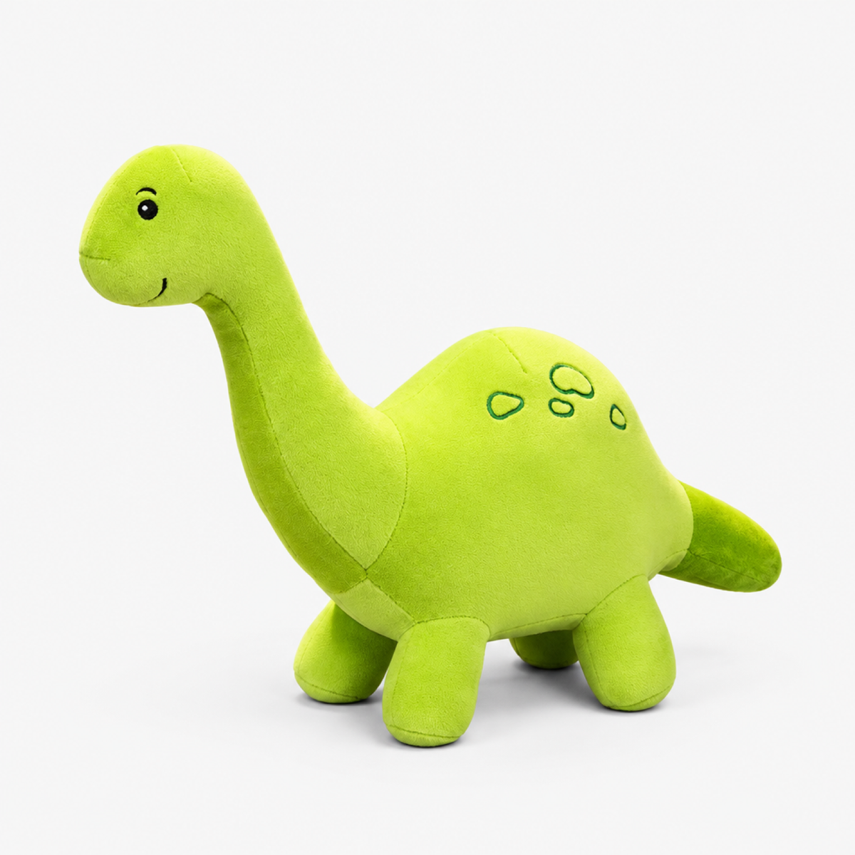 Gros plan sur le tissu peluche doux et les coutures de la peluche dinosaure