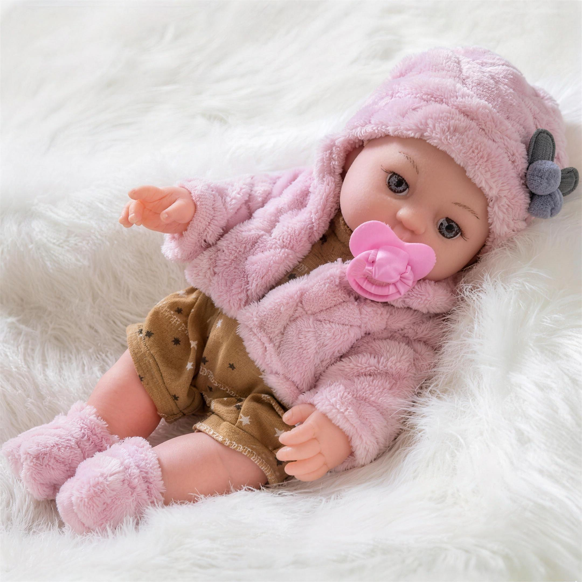 Poupon silicone réaliste en tenue tricotée rose avec tétine