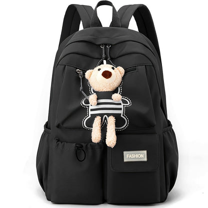 Sac à dos scolaire enfant noir avec porte-clés ourson en peluche, vue de face