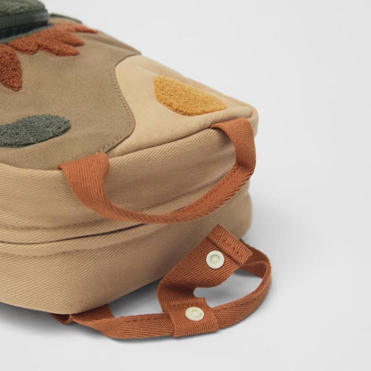 Sac à dos dinosaure ouvert montrant le compartiment intérieur